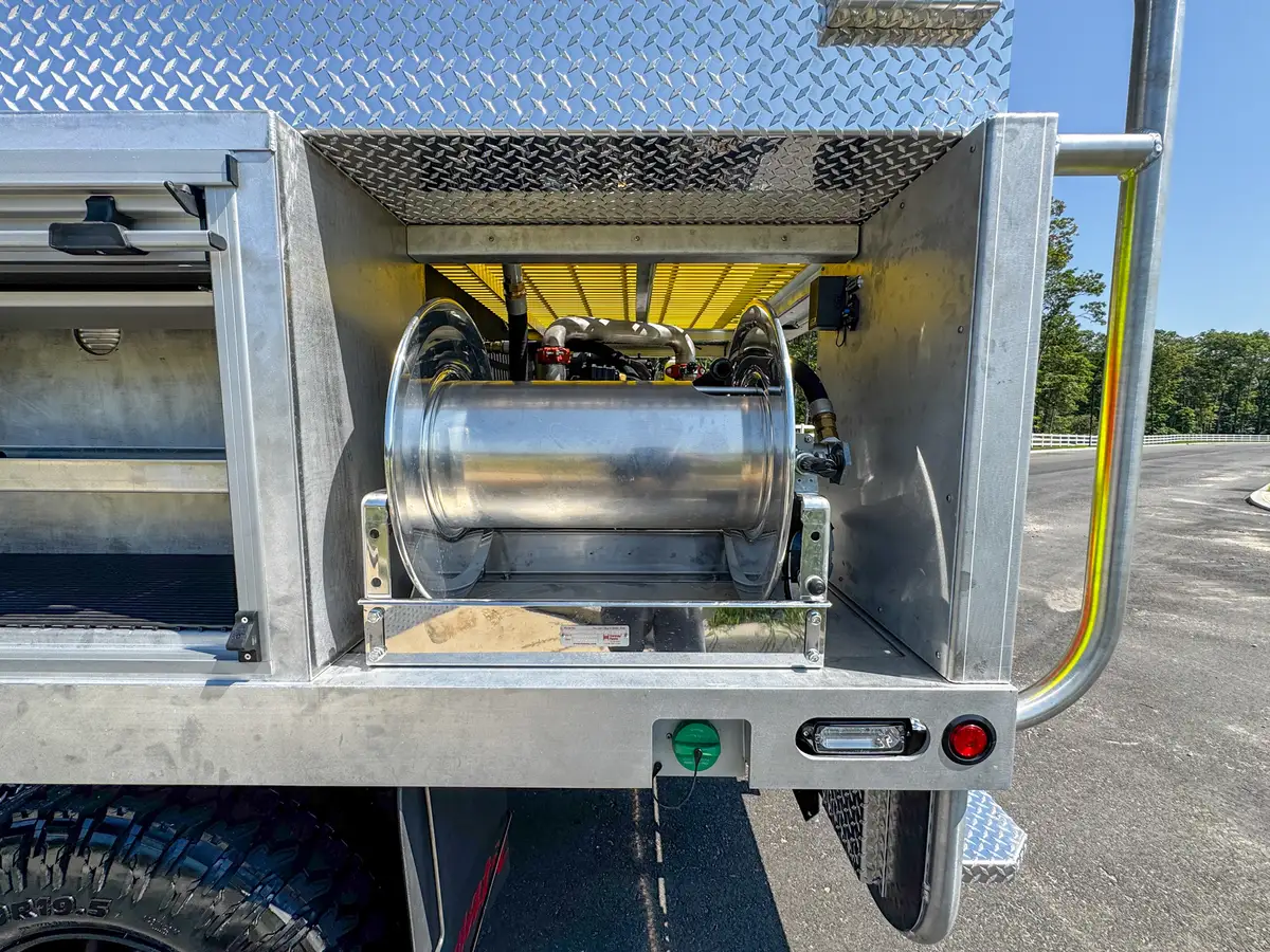 Lower side compartment open by rear wheel with fold-down door platform.